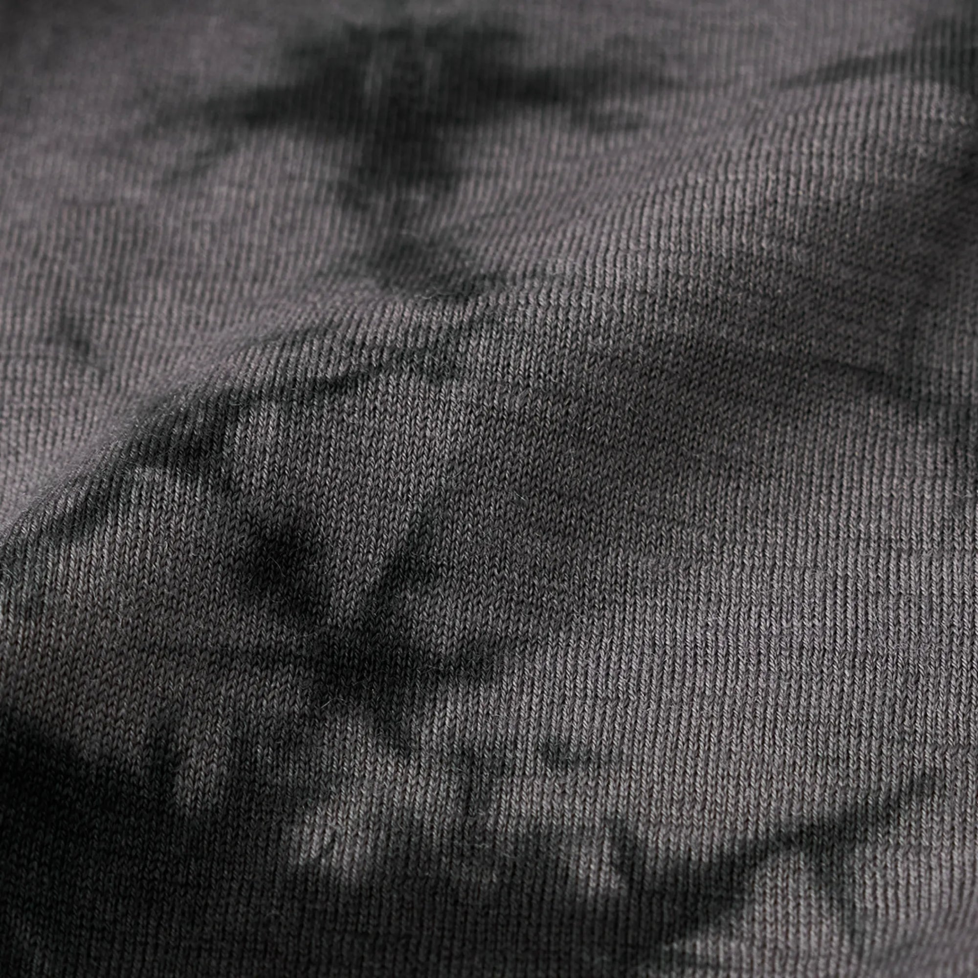 Close-up of dark gray fabric with a subtle pattern