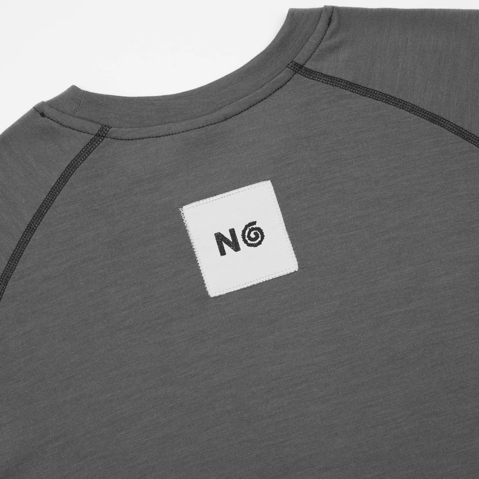 Gray long-sleeve shirt with a logo patch against a white background