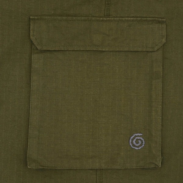 Close-up of a green pocket with a small spiral logo on a green background