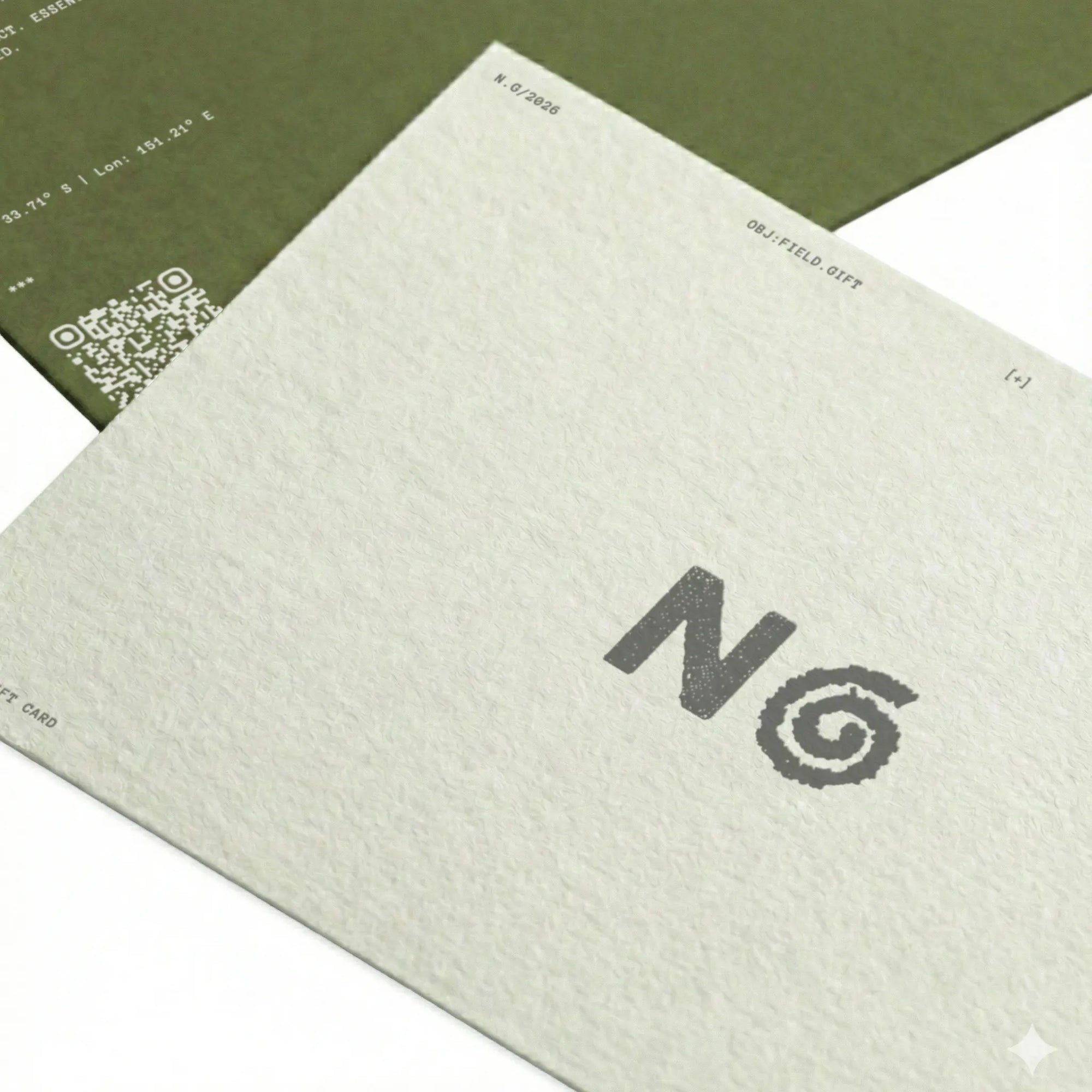 Close-up of a textured card with a logo and QR code on a white background