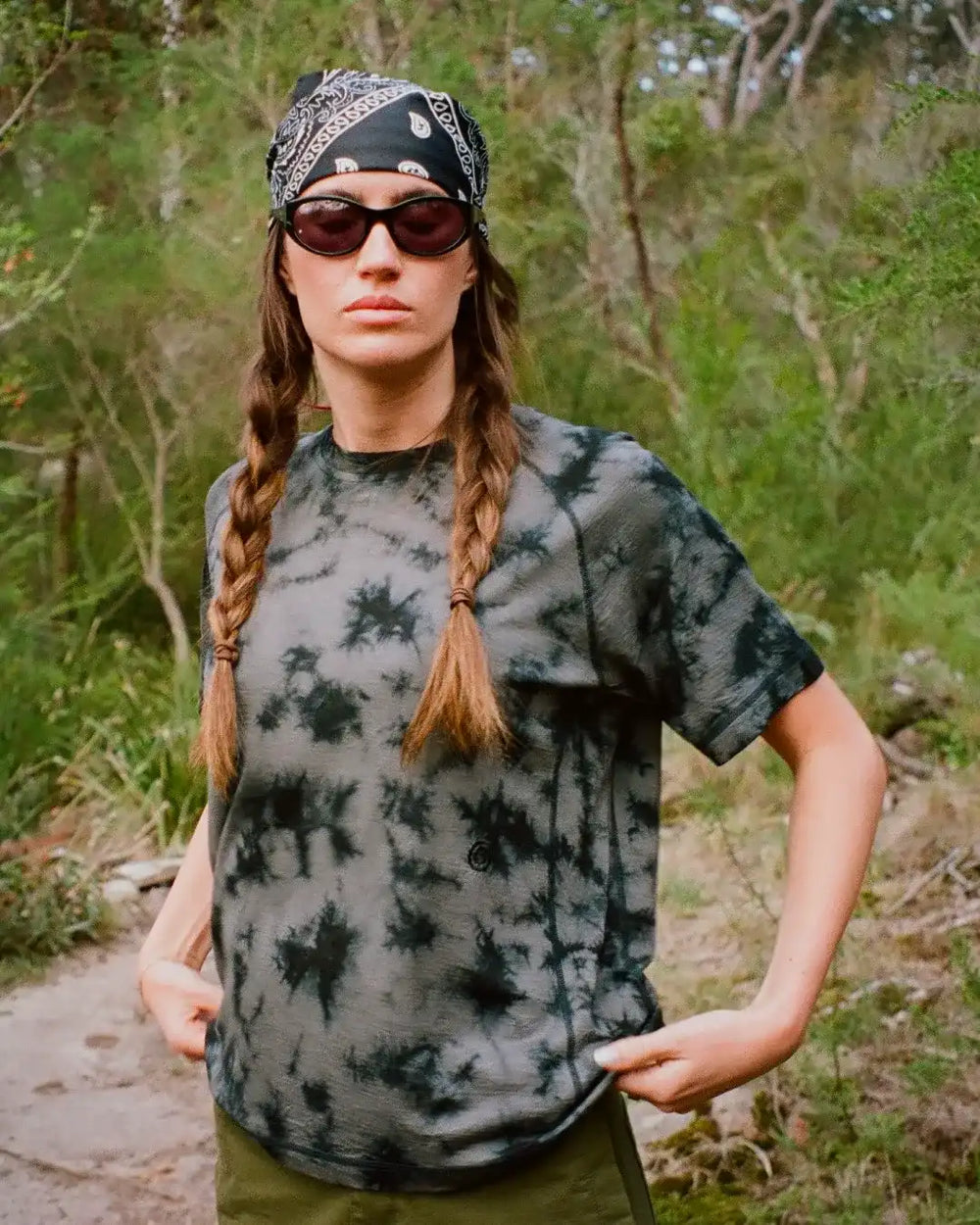 Person wearing a tie dye merino t-shirt outdoors.