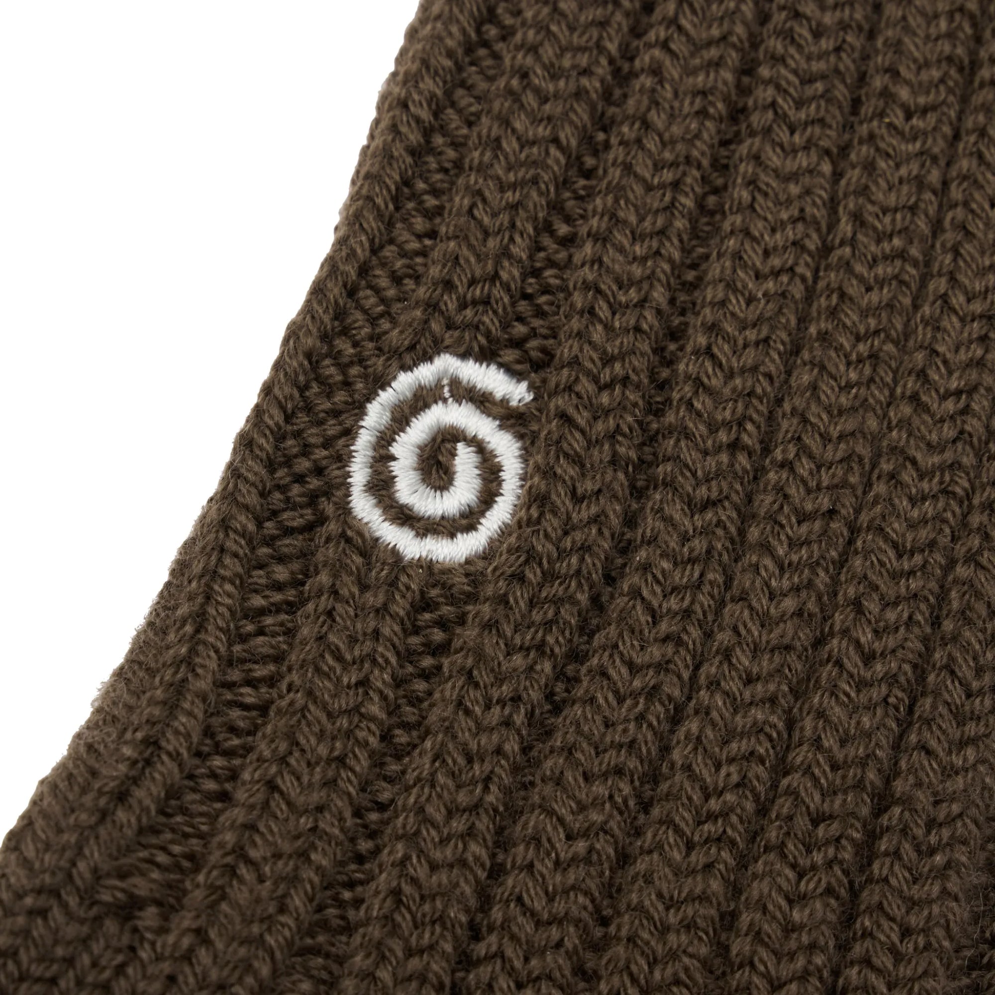 Brown knitted fabric with a white spiral design on a white background